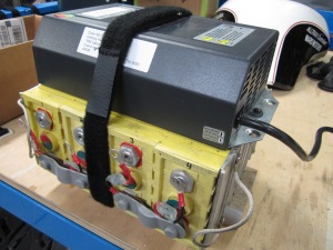 NG1 charger strapped to one top battery module
