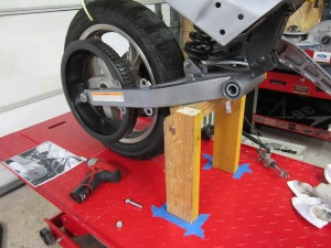 Wood jig to hold swing-arm in place for measurements. 